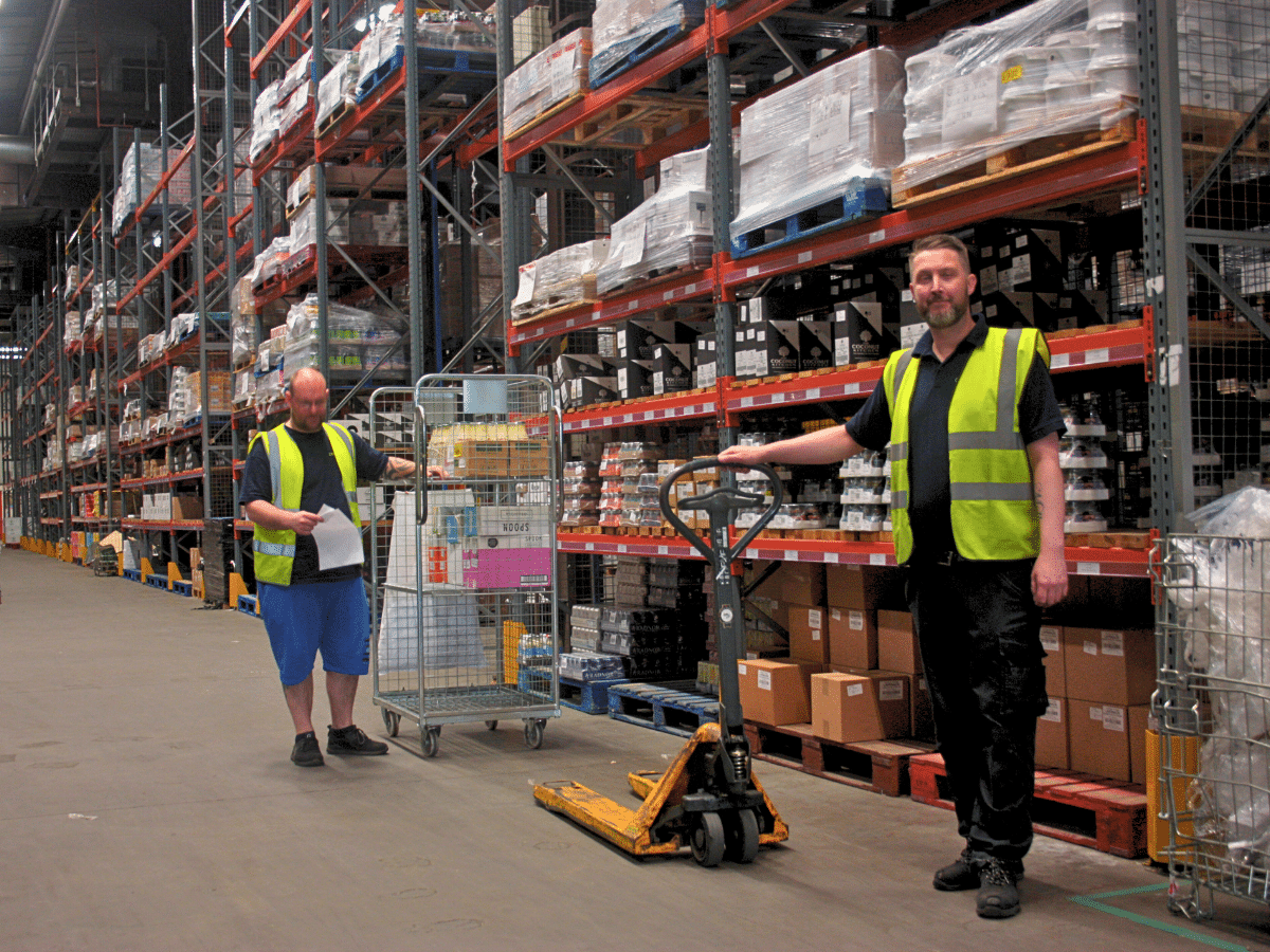 Image of The Cress Company employees in a warehouse, smiling at the camera.